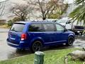 A blue 2020 Dodge Grand Caravan parked with black wheels and a sleek design showcasing its spaciousness and modern features