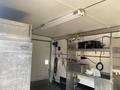 A 2008 Wells Industries Inc EW1422 unit with shelves containing kitchen equipment including a sink and various appliances