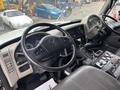 The interior of a 2013 International DuraStar 4300 featuring a steering wheel and dashboard with gauges and controls