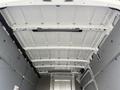 Interior view of a 2023 Mercedes-Benz Sprinter with a white ceiling and no cargo present