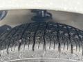 Close-up of a wet tire with deep tread on a 2008 Suzuki Carry showcasing its durability and grip on the surface