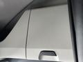 Interior panel of a 2022 Freightliner Cascadia featuring a textured surface and a small handle for opening a compartment