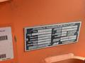 A metal identification plate on a 2009 JLG E300AJP lift displaying specifications including model number and load capacity