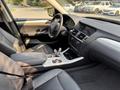 Interior view of a 2013 BMW X3 featuring black leather seats a modern dashboard and a center console with controls and gear shifter