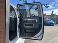 A 2014 RAM 5500 truck with an open driver side door showcasing the interior handle and window controls