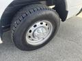 A 2012 RAM 2500 truck tire with a silver wheel and rugged tread design