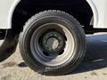 Close-up view of a tire and wheel assembly from a 2009 Ford F-550 showing the tread pattern and lug nut design