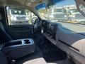 Interior of a 2013 Chevrolet Silverado 1500 featuring a driver's seat and dashboard with various controls and a central console