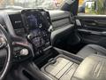 Interior view of a 2021 RAM 1500 showcasing a central touchscreen display and leather seating with detailed stitching