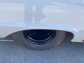 Close-up of a 1962 Ford 2WHDR showing the black wheel and tire with a tread pattern and shiny hubcap