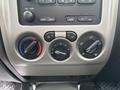 Dashboard controls of a 2011 Chevrolet Colorado featuring climate control knobs for temperature and air settings