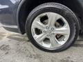 Close-up of a shiny chrome wheel and tire from a 2015 Dodge Durango showing five spokes and the tire tread pattern