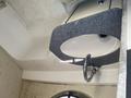 A 2013 Larson 238 boat features a curved sink with a silver faucet and a black countertop surrounding it