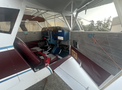 Interior view of a 1986 Sorrell Hiperbipe SNS-7 Amateur-Built Aircraft featuring a cockpit with blue control panel and maroon seating
