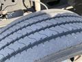 Close-up of a tire from a 1996 GMC Top Kick showing tread patterns and surface detail