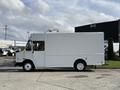 A white 2017 Freightliner MT45 step van with a boxy shape and sliding side door parked on a concrete surface