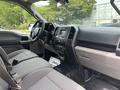 Interior of a 2017 Ford F-150 featuring a gray seating area dashboard and control panel with various buttons and screens