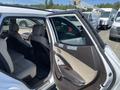A 2018 Hyundai Santa Fe with an open rear door showing the interior seats and door panel clearly visible