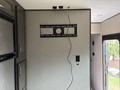 Interior wall of a 2021 Jayco Jay Flight with a black mounting bracket and exposed wiring