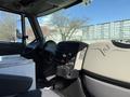 Interior view of a 2008 International 7500 truck featuring a driver's seat dashboard controls and storage compartments