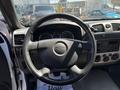 The interior view of a 2011 Chevrolet Colorado showing the steering wheel and dashboard with gauges and controls
