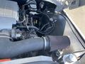 Close-up of a 1962 Ford 2WHDR engine showing the air intake filter and various engine components including hoses and wiring