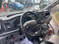 Interior view of a 2021 Ford Transit-350 showing the steering wheel dashboard controls and infotainment screen
