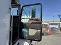 A 2009 Kenworth T270 truck door is open, showing the interior handle and window, with a view of the cockpit area inside the vehicle