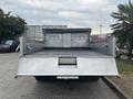 Rear view of a 2014 Ford F-550 truck with an open dump bed and metal sides ready for loading materials