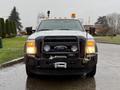 A 2015 Ford F-450 with a front grille guard and two mounted lights on the front bumper