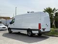 A 2023 Mercedes-Benz Sprinter van in white with a long cargo area and a black stripe along the bottom