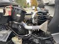 Close-up of the engine compartment of a 2013 Freightliner 114SD showing various components including the air filter housing and piping