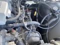 Engine components of a 1962 Ford 2WHDR with various hoses wires and attachments visible in the foreground