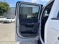 2021 Ford F-150 with an open front door showcasing the interior handle and armrest design