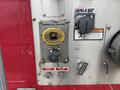 Close-up of the control panel on a 2006 E-One Typhoon showing the power-fill system, foam inlet, foam flush button, and a warning label
