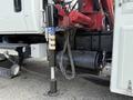 A hydraulic jack mounted on a 2008 International 4300 truck with visible hoses and fittings