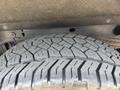 Close-up of a tire from a 2017 Chevrolet Silverado 1500 showcasing its tread pattern and wear
