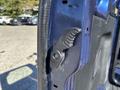 Close-up of a black door latch mechanism on the side of a 2016 Ford Transit 150 van