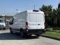 A white 2022 Ford Transit van parked with its rear view visible showcasing its sleek design and large cargo space