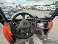 Interior view of a 2011 Kubota RTV 1140 CPX showing the steering wheel dashboard controls and gear shift