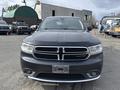 A 2015 Dodge Durango in dark gray color featuring a prominent front grille and headlights with a sleek design