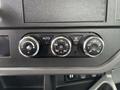 Control panel with three circular knobs for climate settings displaying temperature indicators and an AUTO button