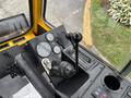 Control panel of a 2004 Bombardier SW48 featuring gauges a gear shift lever and a key ignition