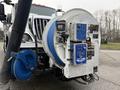 A 2013 International Workstar 7500 equipped with a large blue hose reel and control panel featuring various gauges and buttons for operating the equipment