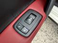 A close-up of the door control panel of a 2016 Maserati Ghibli featuring buttons for locking and unlocking the doors