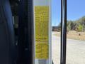 A yellow label attached to a 2004 American LaFrance Eagle providing vehicle specifications and safety information