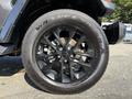 A close-up of a black wheel from a 2021 Jeep Gladiator featuring a five-spoke design and Wrangler SRA tire