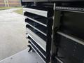 A 2023 Ford Transit featuring multiple storage shelves designed for tools and equipment with a practical, organized interior layout