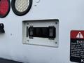 Control panel with buttons labeled raise lower and tools for operating outriggers on a 2013 International Durastar 4300