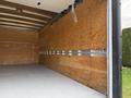 2022 Ford E-450 open cargo area with wooden walls and a bare floor ready for hauling items
